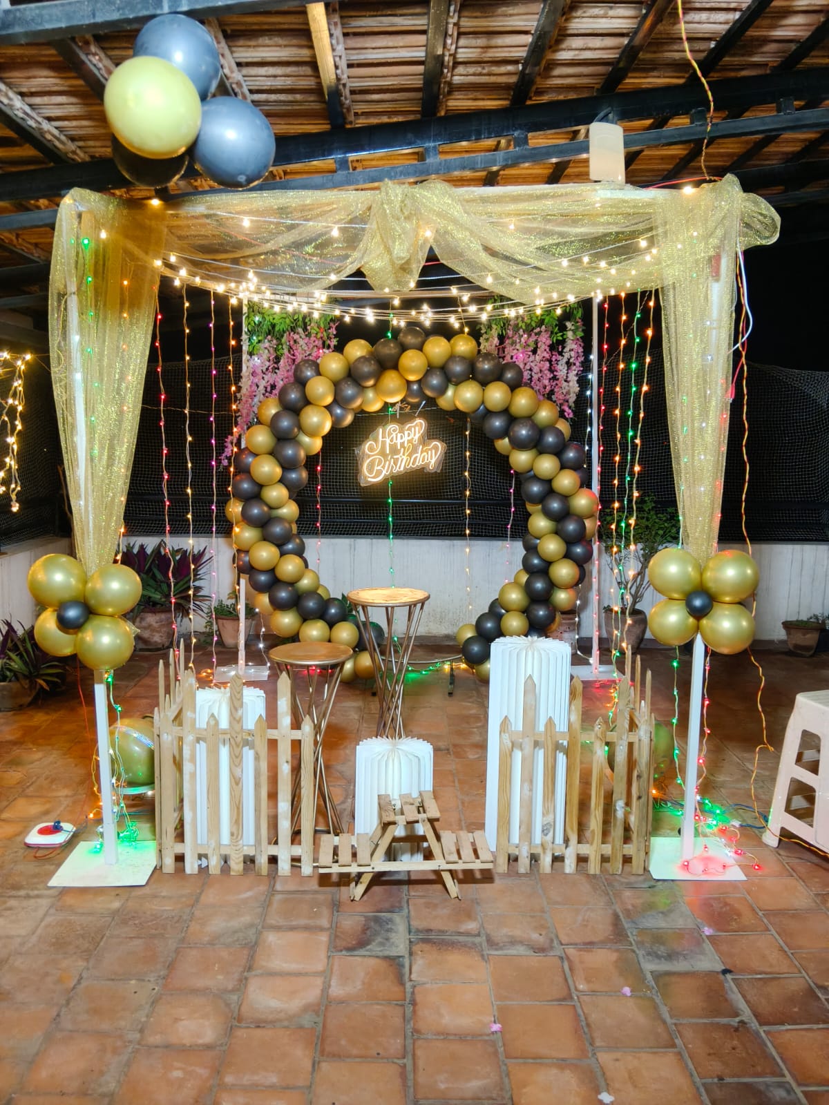 Close-up of ivory roses and gold candlesticks styled on a banquet table