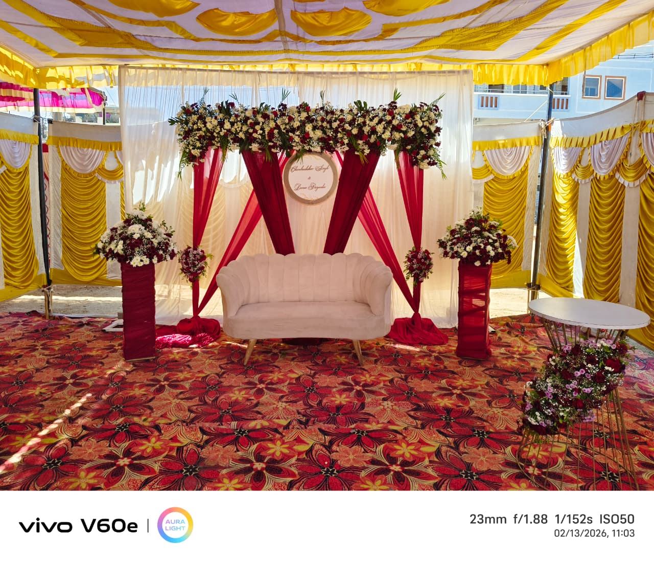 Elegant decorated reception hall with ivory drapes and tall floral centrepieces